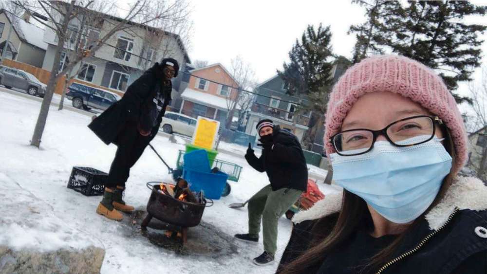 Supplied photo
(From left) Mungala Londe, youth and families manager, Toryan McCorrister, firekeeper and WE24 and onsite Warming Centre manager Melissa Crait tend the outdoor fire at the Warming Centre, a new initiative of WE24, Spence Neighbourhood Association and the West Central Women’s Resource Centre.