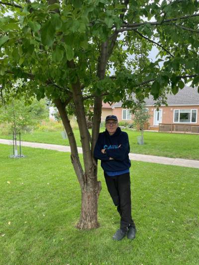Supplied photo
                                Community correspondent Adriano Magnifico leaning on the tree that triggered his TGA episode.