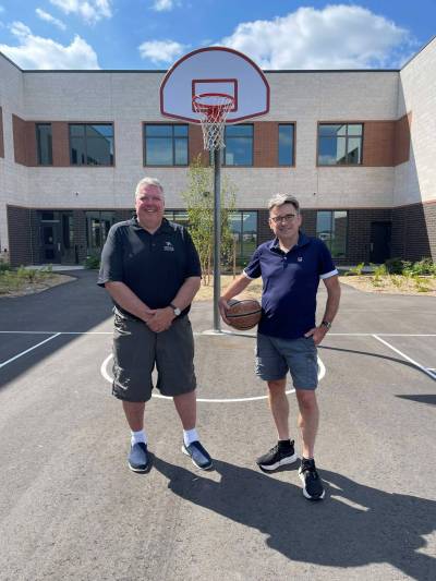Supplied photo
                                The new basketball court at the new Louis Riel School Division French Immersion K-8 school in Sage Creek. Pictured with Coun. Brian Mayes (right) is LRSD board chair Chris Sigurdson.