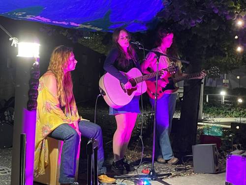 Photo by Doug Kretchmer
                                Prairie Smoke unleash their songs as guest host/ featured performers at CaRaVaN Open Mic on Sept. 15 at Millennium Library courtyard.
