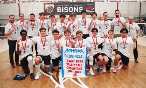 Photo by John Kendle
                                The players and coaches of the St. Paul&rsquo;s Crusaders pose with their AAAA championship banner after defeating the Dakota Lancers in three sets in the varsity boys&rsquo; provincial high school volleyball final on Dec. 1 at Investors Group Athletic Centre at the University of Manitoba.