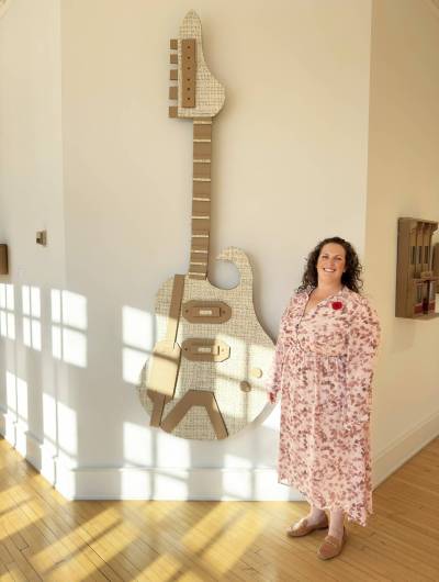Supplied photo
                                Tuxedo MLA Carla Compton stands next to the one of many artworks found within the galleries at Assiniboine Park pavilion.