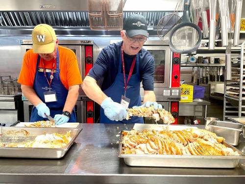 File photo
                                Volunteers slice up turkey breasts for Siloam Mission&rsquo;s annual Thanksgiving meal in October.