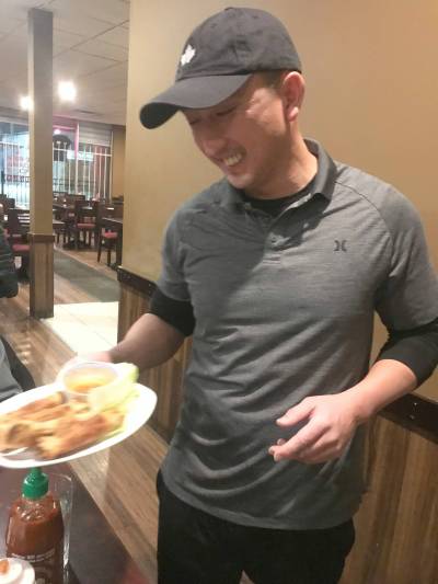 Photo by Anne Hawe 
                                Phuong Nguyen serves spring rolls at Viva Restaurant. His family opened the Sargent Avenue establishment in 1993.