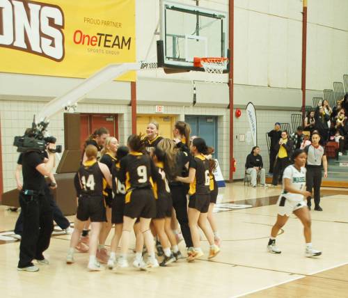 Photo by John Kendle
                                The Dakota Lancers AAAA varsity girls&rsquo; basketball team celebrates its 78-73 victory over the Vincent Massey Trojans at the final buzzer of the final game on March 23.