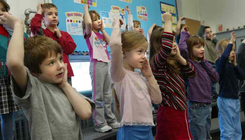 The grade one class at Windsor School rehearsing with music teacher Lisa Kristjanson for the school's Christmas concert. At left are Noah and Meagan. (Wayne Glowacki / Winnipeg Free Press)