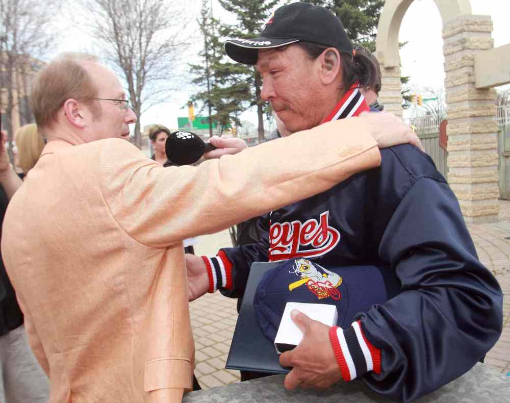 KEN GIGLIOTTI / WINNIPEG FREE PRESS Files
May 6, 2009: Faron Hall gets a hug from mayor Sam Katz after Katz presented him with a City Of Winnipeg Medal, Goldeyes hat and  jacket, and a Goldeyes season ticket pass at a ceremony held  on the Red River Bank near the place where Faron saved a boy from drowning.