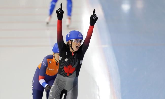 Canada's Ivanie Blondin, foreground, celebrates after winning the women's mass start race as she followed by second placed Irene Schouten, of the Netherlands, during the speed skating World Cup at the Minsk ice arena in Minsk, Belarus, Sunday, Nov. 17, 2019. (AP Photo/Sergei Grits)