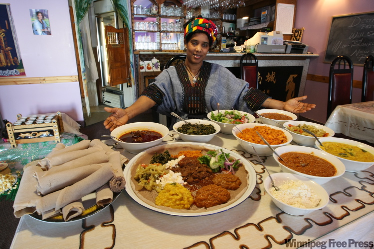 JOE.BRYKSA@FREEPRESS.MB.CA
Desta Work Negatu shows a veggie and meat combo platter at Harman’s Cafe.