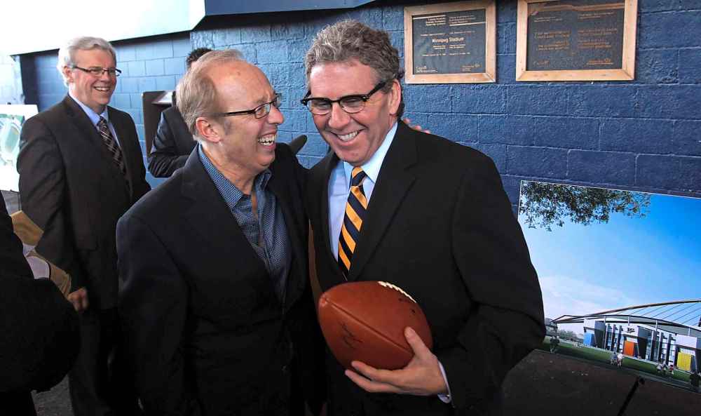 Wayne Glowacki / Winnipeg Free Press files
Under the grandstand in Canad Inns Stadium Wednesday, Mayor Sam Katz congratulates David Asper, Executive Chairman of Creswin Properties Inc. after the announcement of a plan to accelerate the construction of the stadium that would become Investors Group Field.