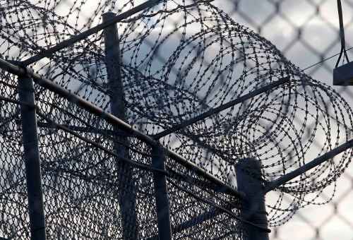 KEN GIGLIOTTI / WINNIPEG FREE PRESS / NOV. 12 2010 ���KEN GIGLIOTTI / WINNIPEG FREE PRESS / NOV. 12 2010 ��� Bruce Owen Story ��� in pic razor wire at Stony Mountian Pen -Minister of Public Safety Vic Toews  is announcing the expansion of Stony Mountain and Rockwood institutions , $45 Million  will be spent to expand the facilities adding 96 beds at Stony and  50 beds  living units at Rockwood ��� Vic Toews corrections officers protesting  his visit outside the  jail while guards from the same union formed an honour guard for the minister penitentiary