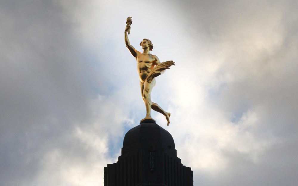 Morning light pours on the golden boy at the Manitoba Legislature Wednesday morning in Winnipeg. Sculpted in 1918 in France the 5.25 m statue was first erected on the dome of the Legislature in 1919 and continues to be a symbol of Manitoba. -Standup photo- Sept 11, 2013 (JOE BRYKSA / WINNIPEG FREE PRESS)