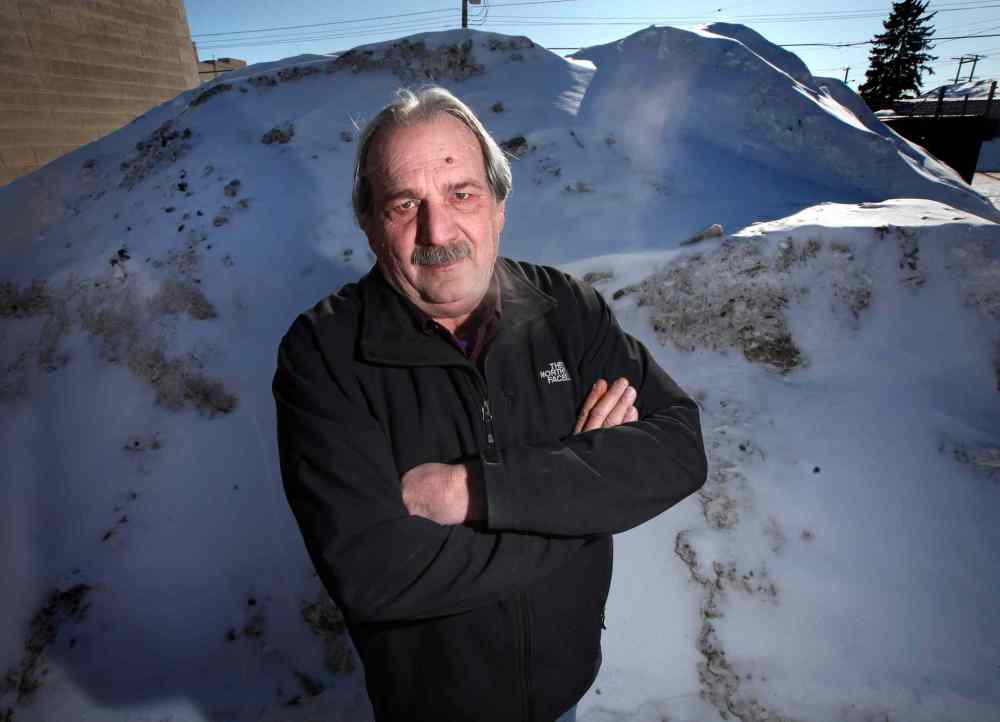 Phil Hossack / Winnipeg Free Press
Gino Riccio poses in front of the evidence: he caught city snow clearing crews dumping snow in his parking lot and has them on surveillance tape.