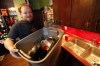 John Woods / Winnipeg Free Press
Scott Wachal loads his dirty dishes into a container at his Cathedral Avenue home Monday. Wachal's water pipes are frozen and he hasn't had water for two weeks.