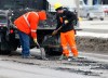 KEN GIGLIOTTI / WINNIPEG FREE PRESS
A pothole-fixing crew fills in some of the many holes on the notoriously pockmarked St. James Street Tuesday.