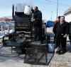 KEN GIGLIOTTI / WINNIPEG FREE PRESS
Mayoral candidate Mike Vogiatzakis (right, wearing tie) looks on as Pellet Patch sales rep Saverio Marra demonstrates his pothole reapair technology using asphalt and rubber.