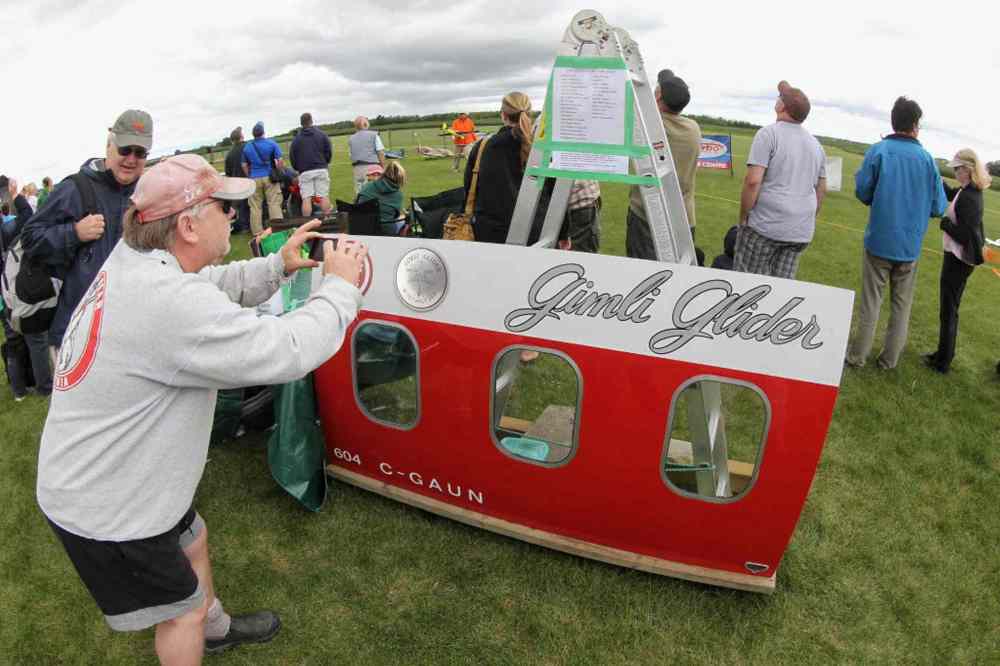 Mike Deal / Winnipeg Free Press
Winnipegger Jeff Kelsey takes a photo of a piece of the Gimli Glider that was on display at the Gimli Model Airplane Festival today.