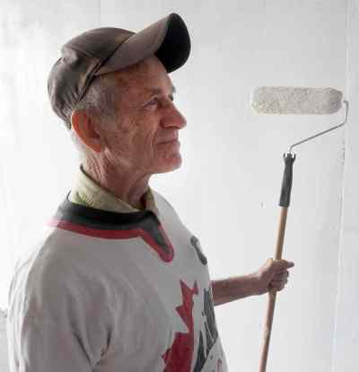 Sel Burrows joins the Point Douglas Residence Committee Green Team that took part in painting the dark underpass near Main Street and Higgins Avenue white to brighten it up.  (Joe Bryksa / Winnipeg Free Press)