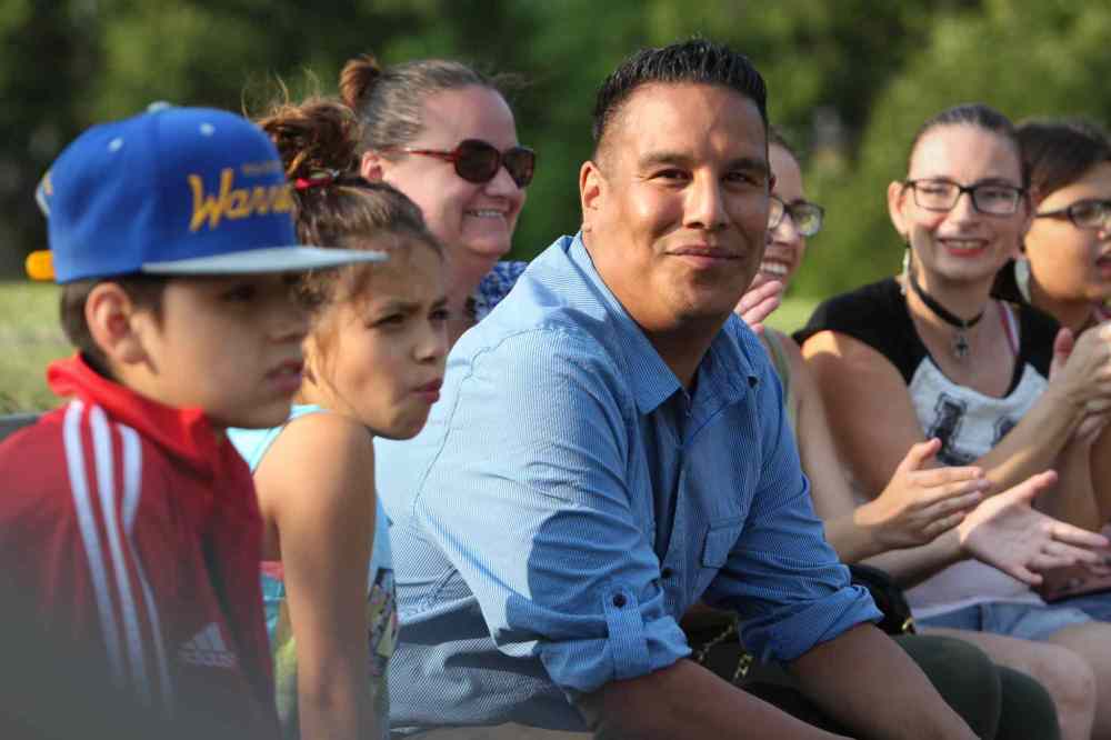 RUTH / BONNEVILLE WINNIPEG FREE PRESS
The producer for a fundraising concert callied - Comminities Building Communities - Matt Thordarson, sits with a group of young people watching the first performer, Jersey Siebrecht (9yrs) sing on the open stage at Joe Zuken Park in Point Douglas Saturday. Funds raised from free concert will go towards North Point Douglas Women's Centre.
See Randy Turner story.
Aug 19, 2017