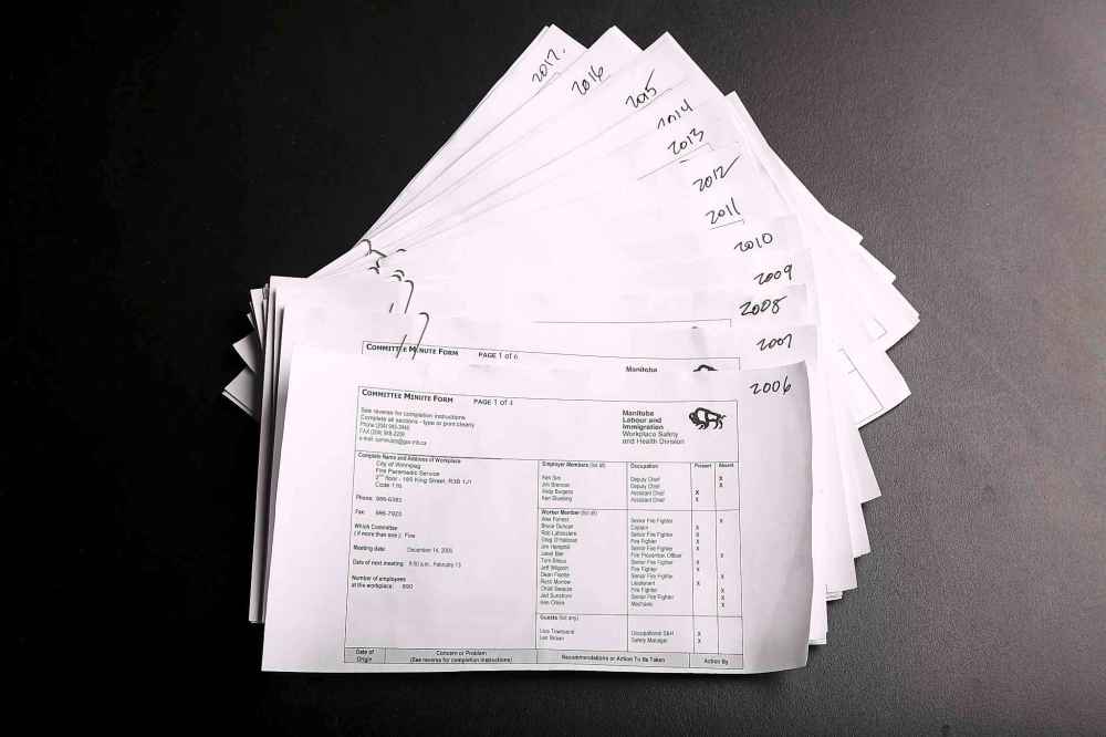 MIKE DEAL / WINNIPEG FREE PRESS
Committee minute forms from between 2006 and 2017 that list members of the Fire Committee for the Manitoba Labour and Immigration Workplace Safety and Health Division and wither they were present or absent for each of the meetings.