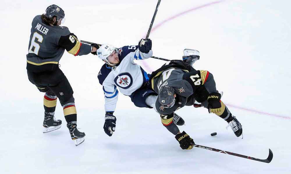 TREVOR HAGAN / WINNIPEG FREE PRESS FILES
Vegas Golden Knights' Luca Sbisa (47) hits Winnipeg Jets' Jack Roslovic (52) in front of Colin Miller (6) during the second period of game 4 of their Western Conference Final series in Las Vegas, Friday, May 18, 2018.