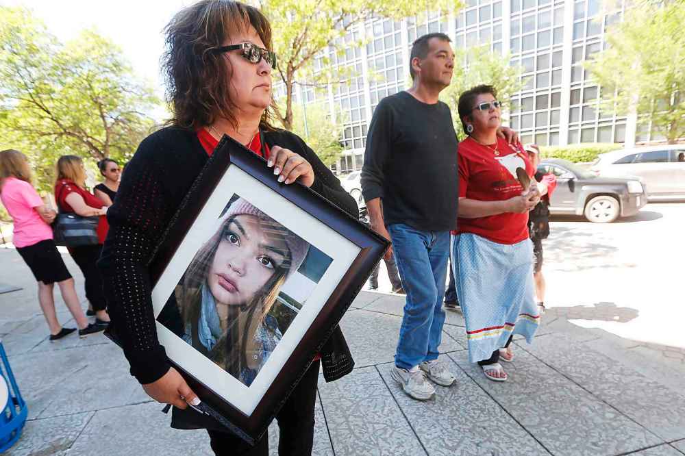 JOHN WOODS / WINNIPEG FREE PRESS
A supporter holds a photo of Serena McKay as Delores Daniels, mother of Serena McKay, leaves the Manitoba law courts with her family after one of her daughters' killers was sentenced to 40 months, 23.5 months supervision for second degree murder Monday.