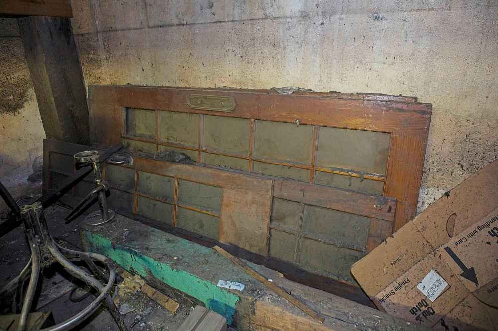 Original oak doors gather dust in the basement of Roxy Lanes. (Mike Deal / Winnipeg Free Press)