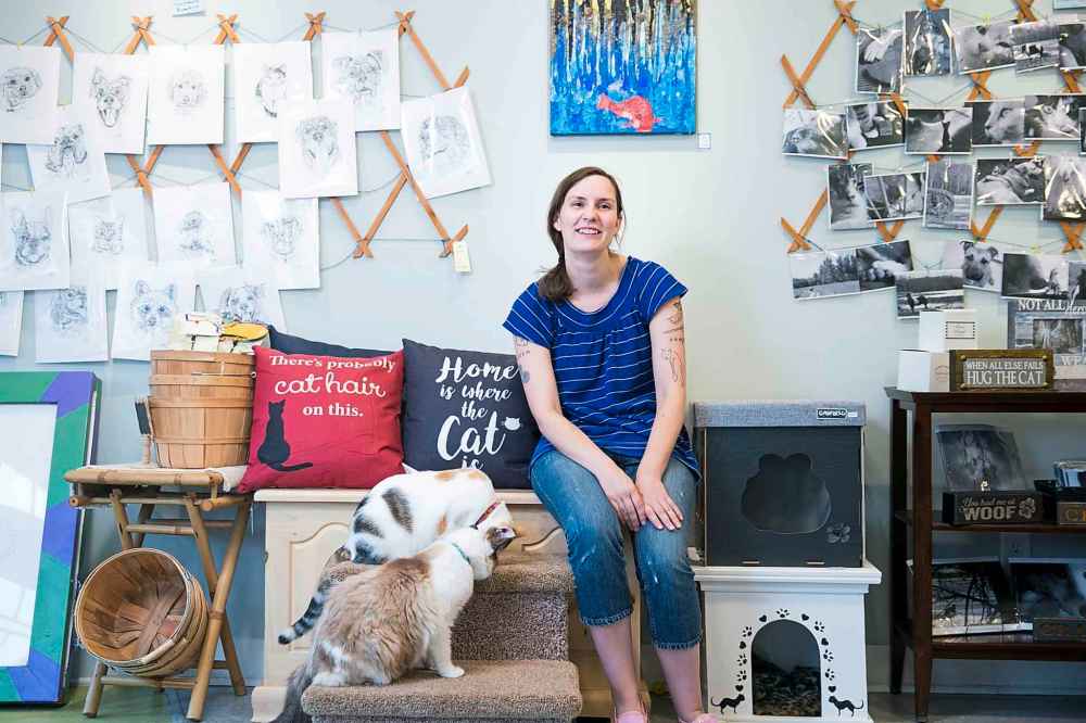 MIKAELA MACKENZIE / WINNIPEG FREE PRESS
Jessica Thompson, CARE Cat Community Outreach Liaison (aka professional cat lady) , poses with a few furry friends at the CARE store in Winnipeg on Wednesday.