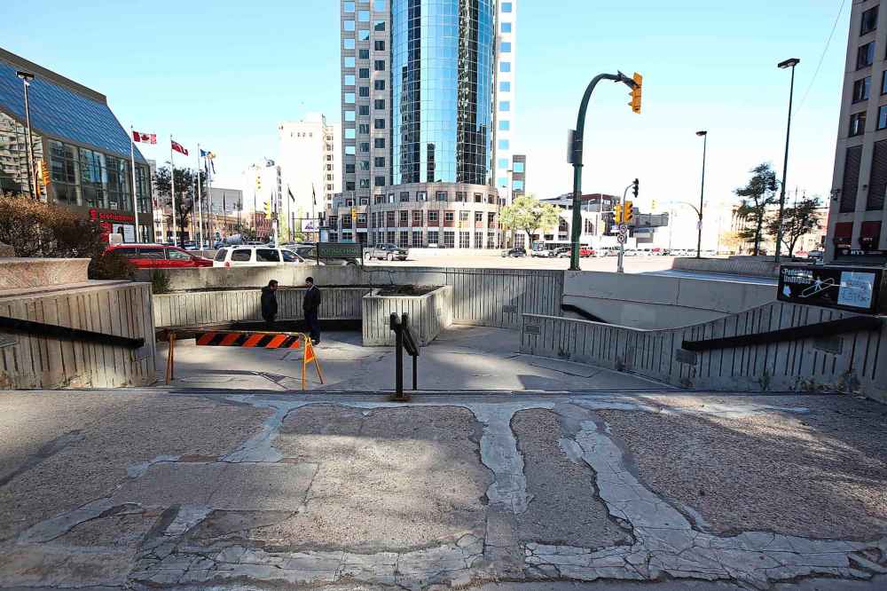 MIKE DEAL / WINNIPEG FREE PRESS
MIKE DEAL / WINNIPEG FREE PRESS
The courtyard at the Bank of Montreal corner of Portage and Main is showing its age with surging concrete pavement and awkwardly patched cracks.
181012 - Friday, October 12, 2018