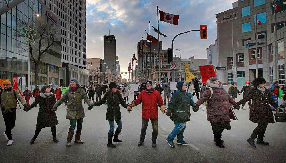 PHIL HOSSACK / WINNIPEG FREE PRESS - Protestors dance at Portage and Main Thursday.