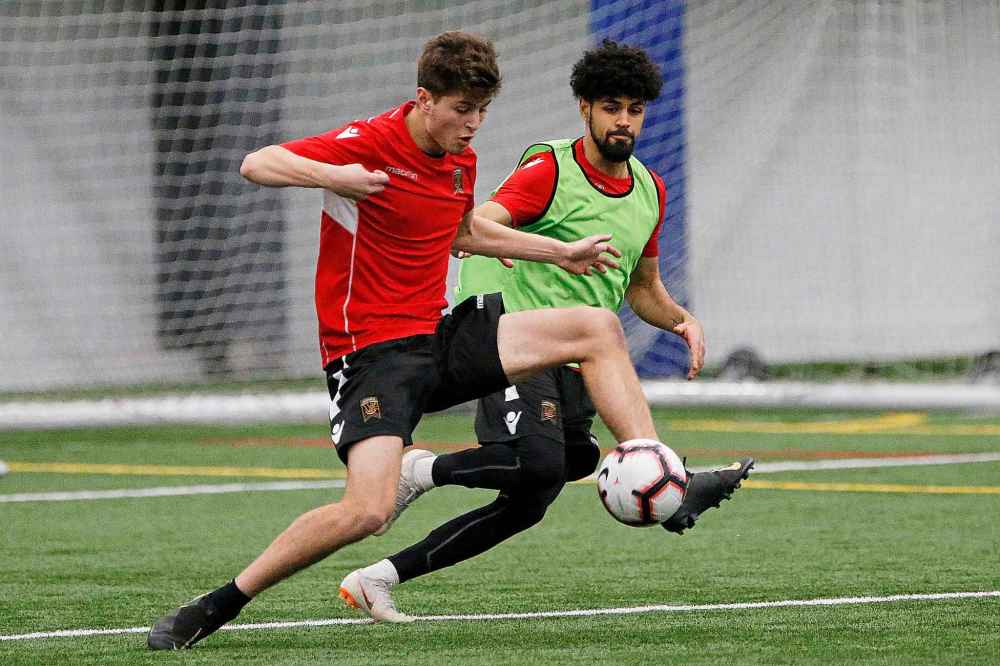 Forward Tyler Attardo (left) fends off Federico Pena during Valour FC's first team practice Monday. (John Woods / Winnipeg Free Press)