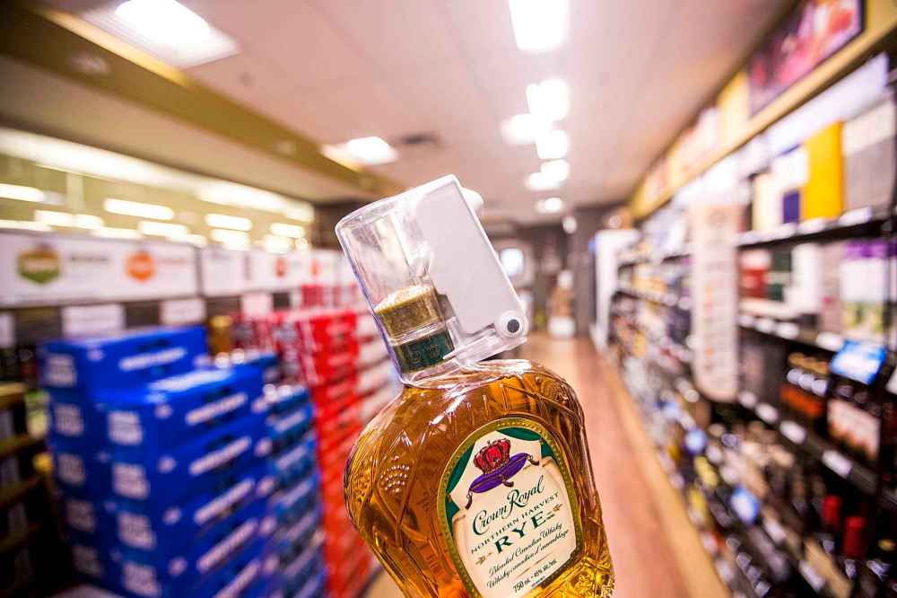 MIKAELA MACKENZIE / WINNIPEG FREE PRESS
Bottle locks, an example of the new theft prevention measures, are seen at the St. James Superstore Liquor Mart in Winnipeg.