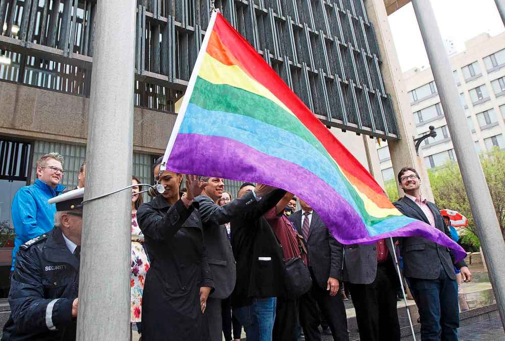 Pride Winnipeg president Muhammad Ahsan, Mayor Brian Bowman and other dignitaries raise the Pride flag at City Hall last Friday. (Mike Deal / Winnipeg Free Press files)
