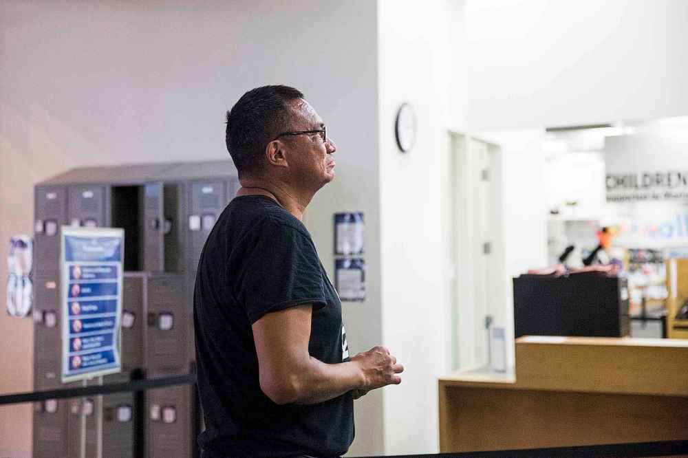 MIKAELA MACKENZIE / WINNIPEG FREE PRESS
Library patron Blaine Albany stands in line for security screening at the Millennium Library Monday.