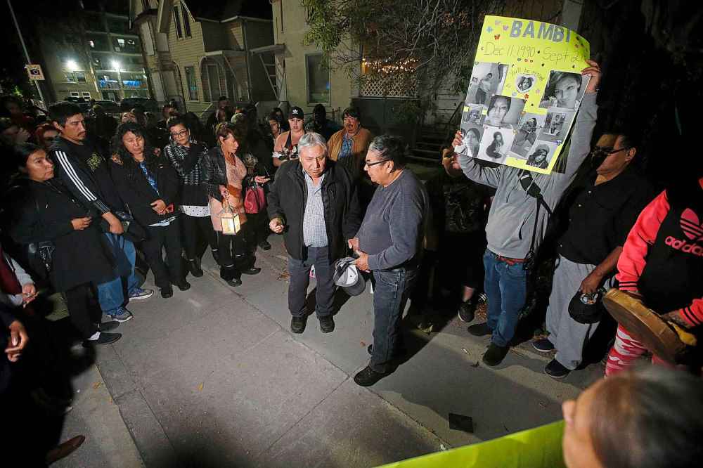 JOHN WOODS / WINNIPEG FREE PRESS
Family and friends gather for a vigil Monday for Norma Andrews in front of the home where she was killed. (John Woods / Winnipeg Free Press)