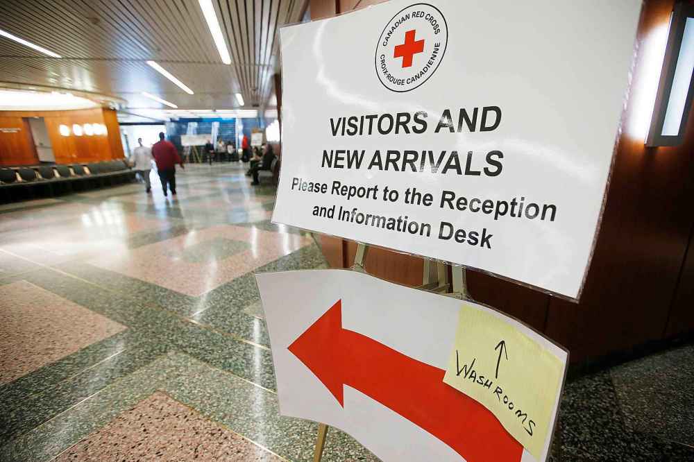 Signage directs storm evacuees to the temporary Red Cross shelter in the convention centre in Winnipeg on Monday. (John Woods / Winnipeg Free Press)
Reporter: Ben