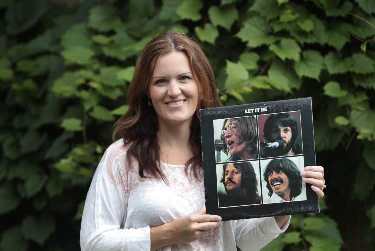 Stacey Nattrass with a copy of Let it Be.
