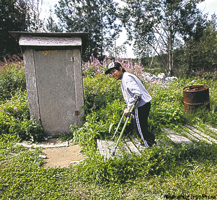 30 year old Kevin Taylor who has Cerebral palsy heads to the outhouse on  his crutches at his home in St Theresa Point First Nation- His mother Alice has filled a Human Rights  to  get proper services for her son on the reservation. Their home has no running water- See Mary Agnes No Running Water Feature � August 19, 2011   (JOE BRYKSA / WINNIPEG FREE PRESS)