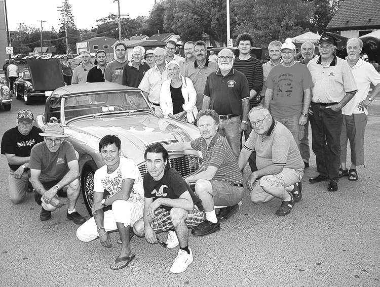 Paul Williamson / Winnipeg Free Press
Members of the Austin Healey Club of Manitoba and the Triumph Drivers Club of Manitoba surround Roger Morcilla's ultra-rare 1960 Austin Healey 3000 at a local show and shine last summer. This year, both clubs have been instrumental in organizing the 2012 Northern Lights Rendezvous, a gala British car event being held in Kenora this June.