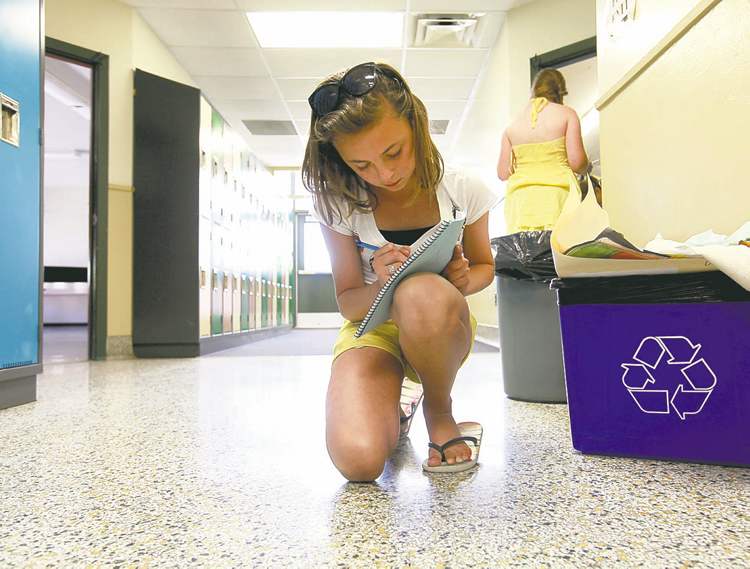 Ruth Bonneville/Winnipeg Free Press
Aby writes in a yearbook before summer vacation starts.