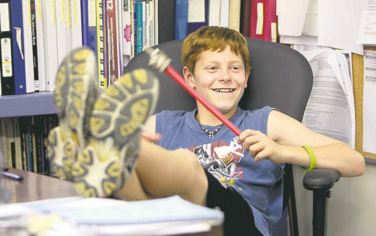 Griffin takes advantage of the last day of school to put his feet up on the teacher's desk.