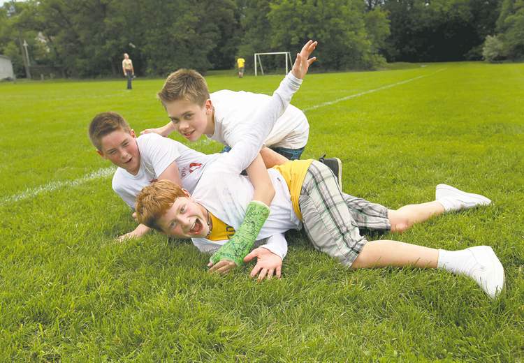 They're going into Grade 8, but boys will be boys. Griffin, Jessie and Avery play fight on the last day of school.