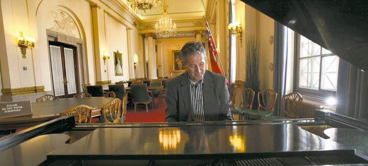 An avid piano player, Pallister takes the opportunity to tickle the ivories in a lounge in the Legislative Building.