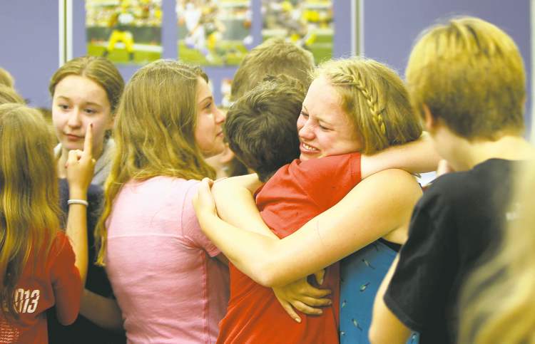 Ruth Bonneville / Winnipeg Free Press
Students share last-day-of-school hugs. Most of them will be together again next year at Glenlawn Collegiate, but two plan to attend other high schools.