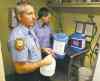 Boris Minkevich / Winnipeg Free Press
Winnipeg firefighters and paramedics prepare water jugs for delivery at Winnipeg Fire and Paramedic Station 22, 1567 Waverley St. Jay Simons and Dale Worrall demonstrate how they are going to clean and fill the water jugs.