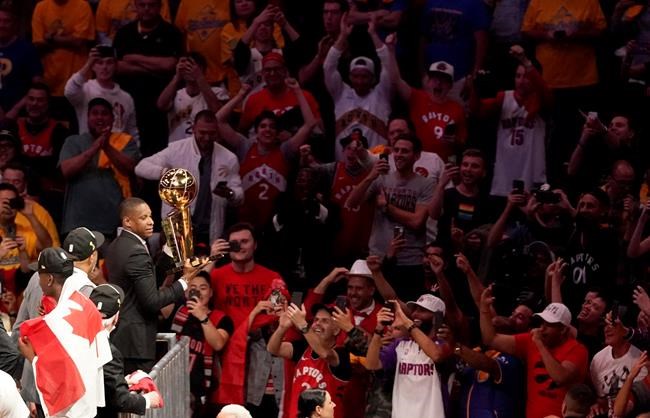 This Thursday, June 13, 2019, photo shows Toronto Raptors general manager Masai Ujiri holding the championship trophy after the Raptors defeated the Golden State Warriors in Game 6 of basketball's NBA Finals in Oakland, Calif. (AP Photo/Tony Avelar)