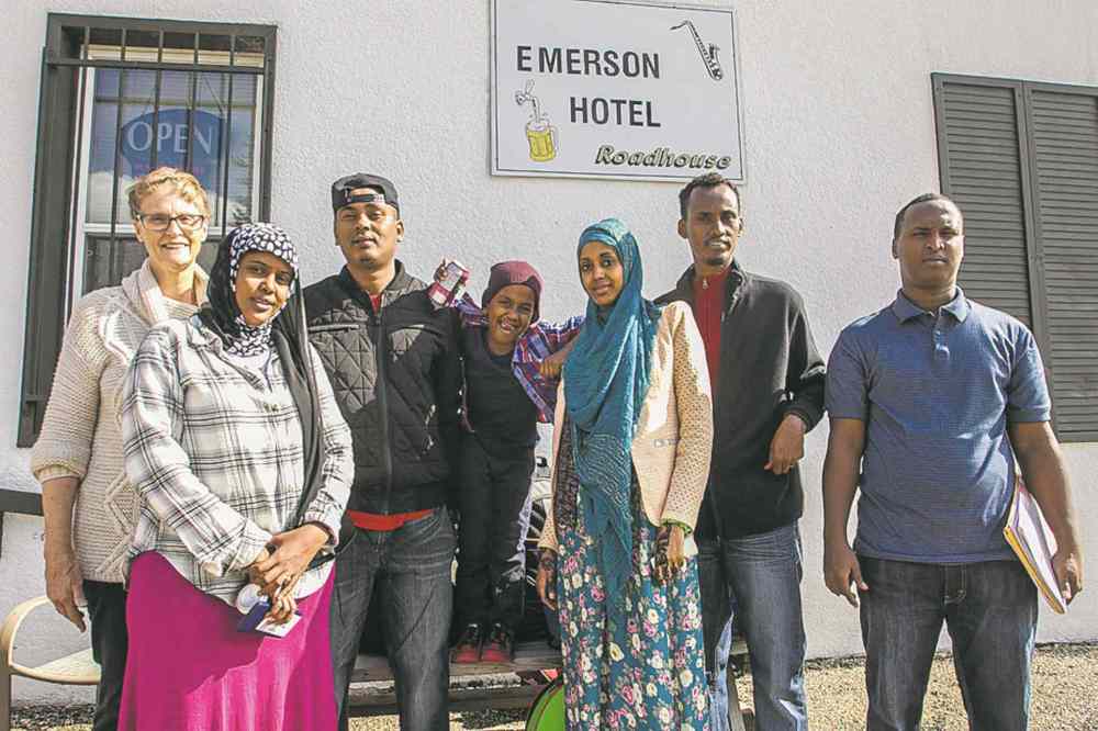 MIKE DEAL / WINNIPEG FREE PRESS 
Karin Gordon (back left) pick up refugees who crossed into Manitoba from the U.S. FROM LEFT: Aasiya Maxmuud, Feysal Osman Malen, Amin, 6, and his mother, Sahra Ali Ahmed, translator Yahya Samatar and Mahad Mohamed.