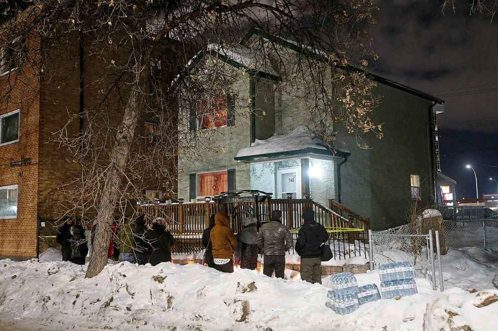 JOHN WOODS / WINNIPEG FREE PRESS FILES
Family and friends outside 745 McGee Street last week at a vigil for Jamie Adao where he was killed in a March 3 home invasion.