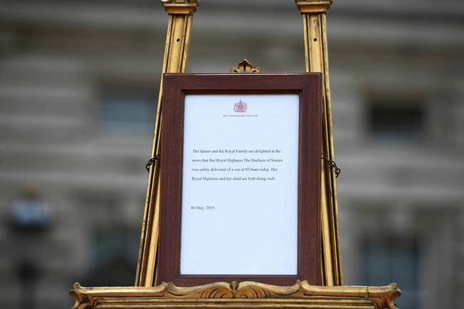 A notice placed on an easel in the forecourt of Buckingham Palace to formally announce the birth of a baby boy to Britain's Prince Harry and Meghan, the Duchess of Sussex, in London, Monday, May 6, 2019. (Yui Mok/Pool Photo via AP)