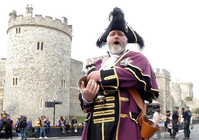 Royal Borough of Windsor and Maidenhead official Town Crier Chris Brown announces the news of the birth of a baby boy to Prince Harry and his wife Meghan, Duchess of Sussex, outside Windsor Castle in Windsor, south England, Monday May 6, 2019, (AP Photo/Alastair Grant)